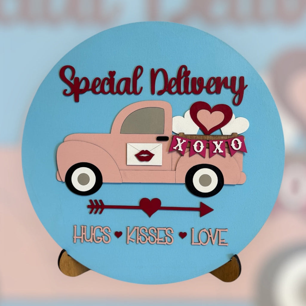 Valentine's Day-themed pink truck with hearts and text on a blue background
