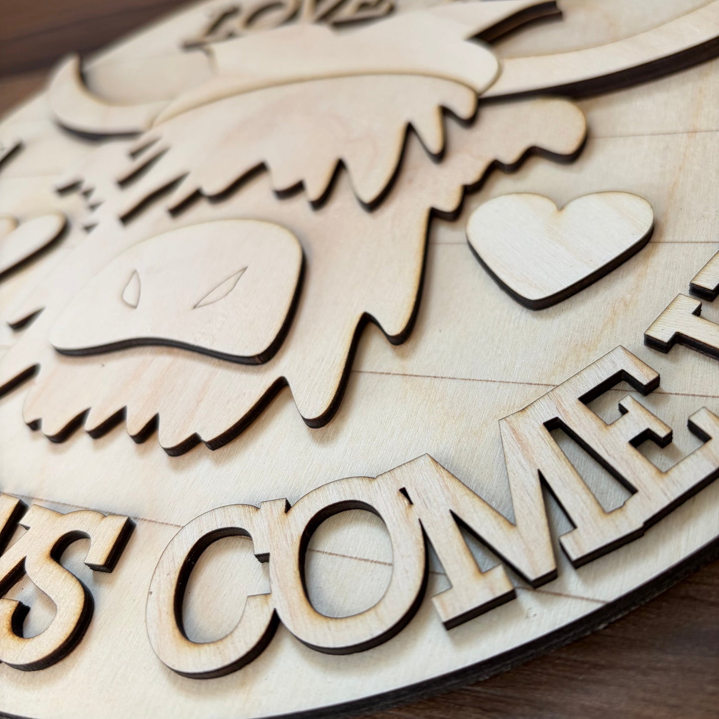 Close up image of a 3D wood DIY kit featuring a highland cow.