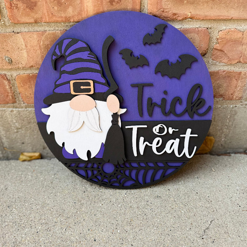 Halloween-themed decorative sign with a gnome, bats, and 'Trick or Treat' text on a purple background.