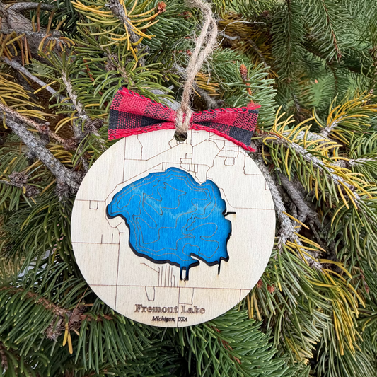 Bathymetric map ornament of Fremont Lake Michigan engraved in wood