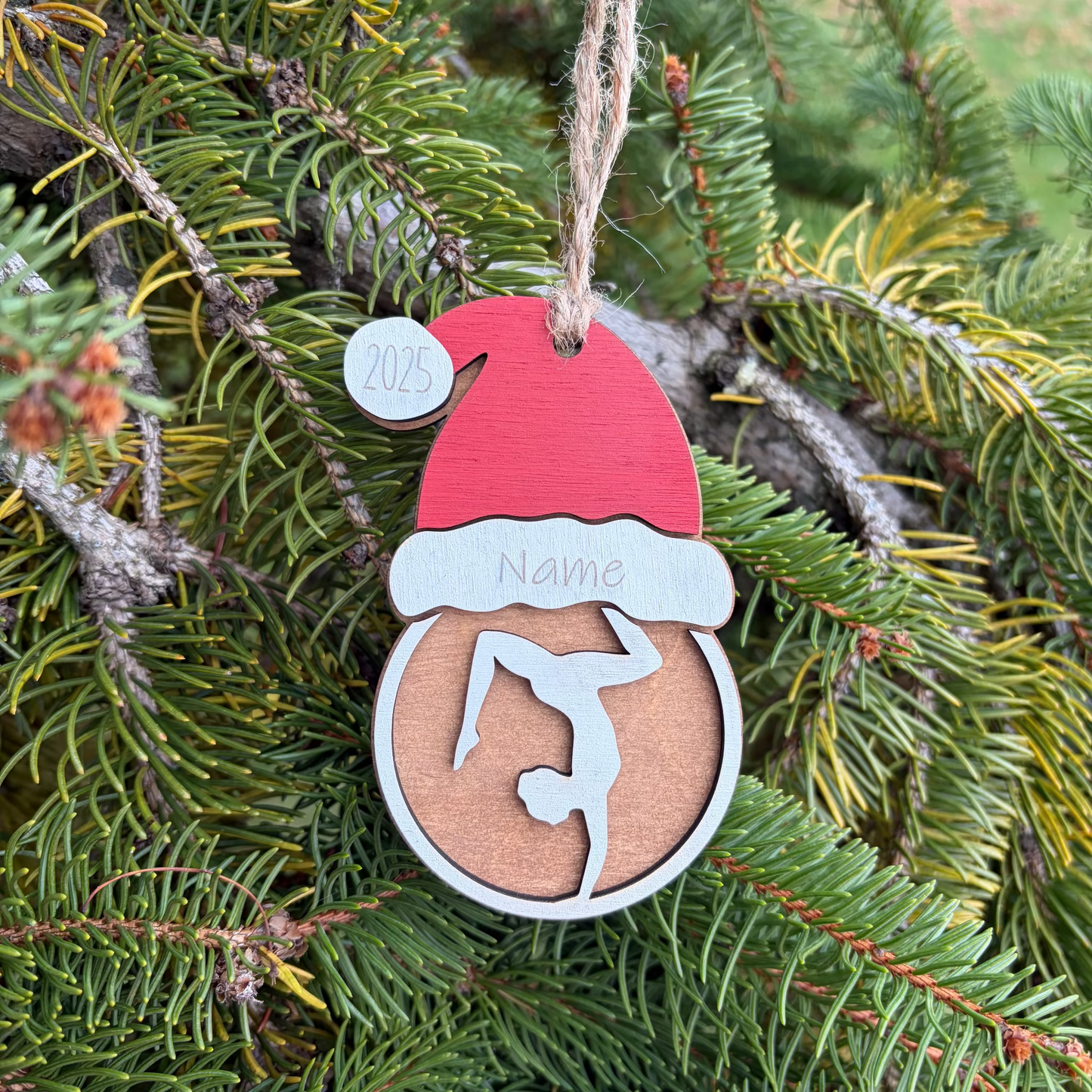 Personalized wooden Christmas ornament for gymnast with a Santa hat.