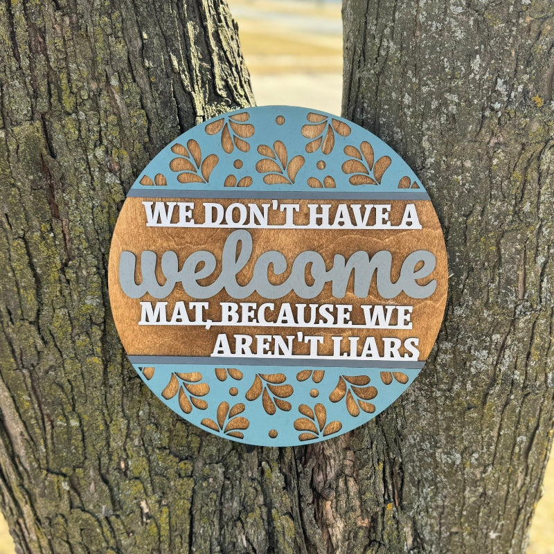 Round wooden sign with snarky text attached to a tree